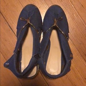 Blue jean shoes with zippers and snaps.